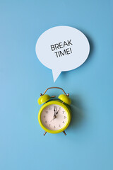 A green alarm clock and the inscription: 