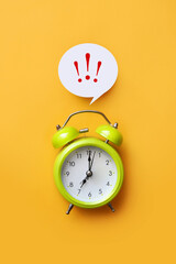 A green alarm clock and exclamation marks above it. A reminder symbol for something