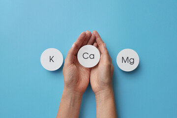 Paper circles with inscriptions: potassium, magnesium and calcium. Choosing calcium from other useful substances