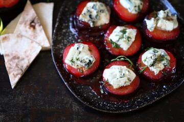 Baked plums with dor blue cheese and thyme. Gourmet recipes with plums. Autumn dishes.