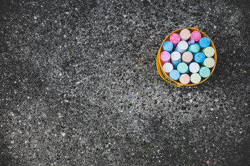 a bucket full of colorful street chalk - obrazy, fototapety, plakaty