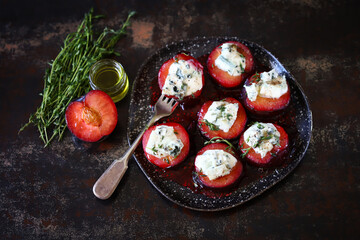 Baked plums with dor blue cheese and thyme. Gourmet recipes with plums. Autumn dishes.