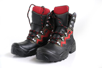 close-up of pair of new high black work boots made of genuine leather with a reinforced cape, the...