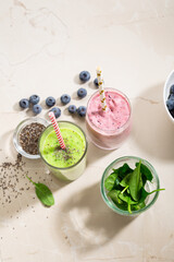 Two glasses of healthy smoothie on stone table