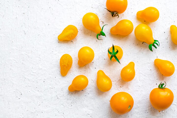 Small yellow tomatoes on white background. Closeup image of yellow pear tomatoes. organic healthy food