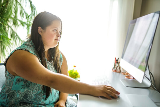 Portrait Of Trisomy 21 Adult Working On Computer