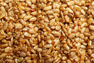 Sweet delicious kozinaki bar as background, top view