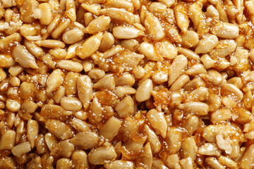 Sweet delicious kozinaki bar as background, top view