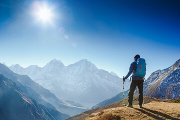 Fototapeta na wymiar Active hiker hiking, enjoying the view, looking at Himalaya mountains landscape. Travel sport lifestyle concept