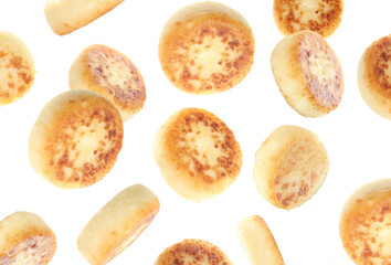 Delicious cottage cheese pancakes falling on white background