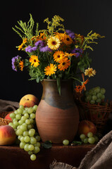 Still life with a jug, wild flowers and fruits in a retro style