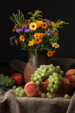 Still life with a jug, wild flowers and fruits in a retro style