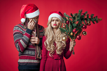 Fototapeta na wymiar sad man and woman holiday dissatisfaction christmas red background