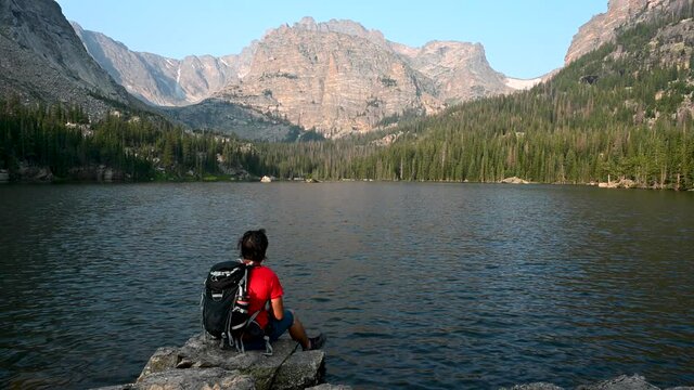 Hiker enjoys mountain views at an alpine lake