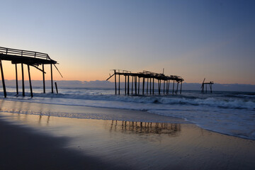 Storm battered broken down pier at sunrise on the Atlantic ocean off the North Carolina Coast