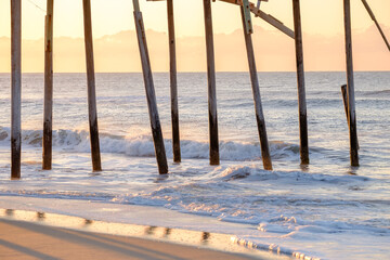Storm battered broken down pier at sunrise on the Atlantic ocean off the North Carolina Coast