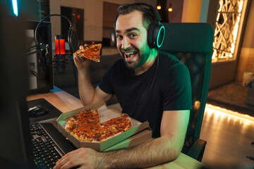 Happy young man in headset with pc computer
