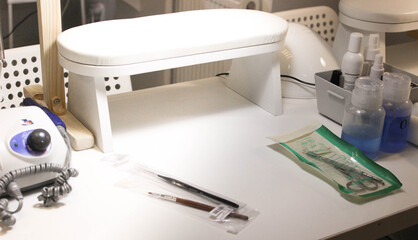 Interior of a nail care studio. White room for a manicure with a lamp and a tool, a ready-made place for a manicurist