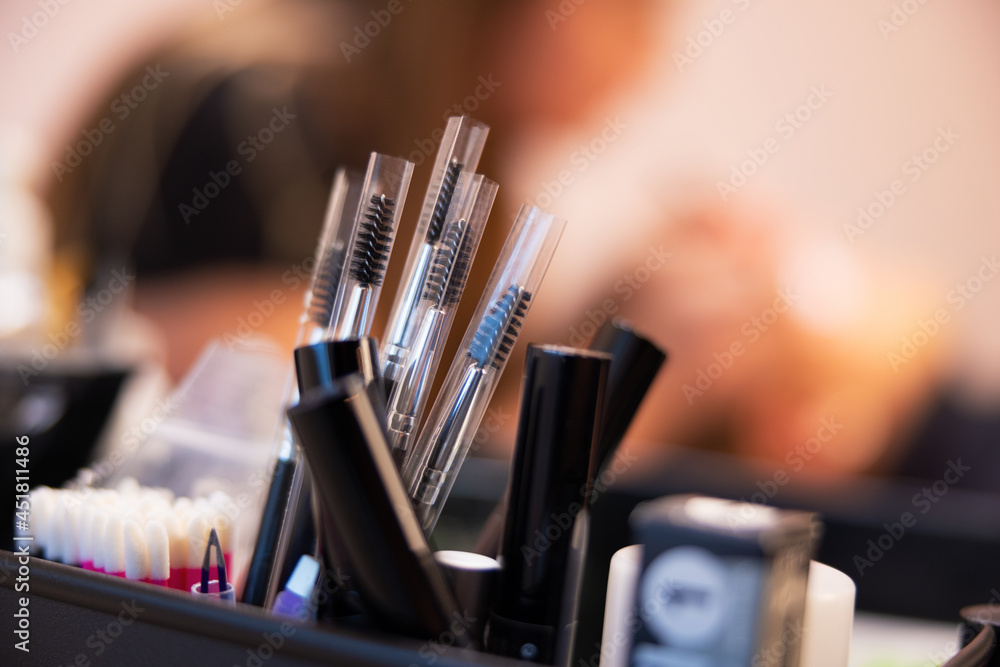 Wall mural closeup of various eyelash extension and makeup products