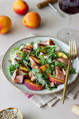 Salad with peaches, arugula, cheese and jamon. Healthy eating.