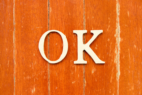 Alphabet letter in word ok on old red color wood plate background