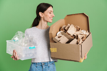 Young brunette woman posing with plastic and paper waste