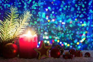 Advent candle with decorations and fir tree isolated on lights background.