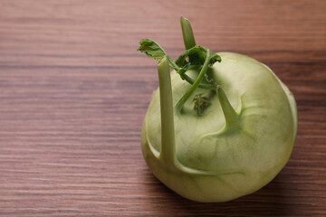 Whole ripe kohlrabi plant on wooden table