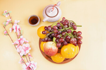 Grape,Apple and Orange put in clay dish,beside Chinese tea cup,
