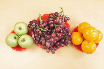 Grapes,Oranges and Apples put on background