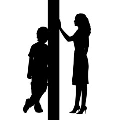 Silhouettes of mom and son separated by wall.
