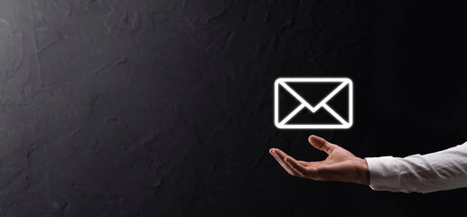 Businessman hand holding e-mail icon, Contact us by newsletter email and protect your personal...