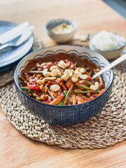 African peanut stew, chicken stew, family meal, dining table, cashew nuts, rattan placemats, rice, curry, dinner