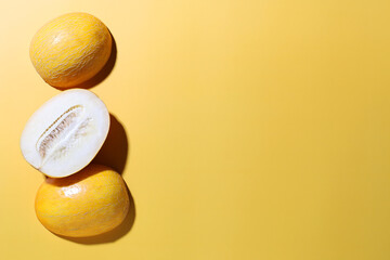 Fresh ripe melons in a cut on a yellow background