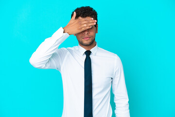 Young business Brazilian man isolated on blue background covering eyes by hands. Do not want to see something
