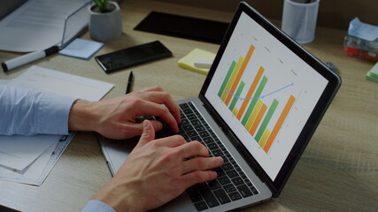 Closeup businessman hands typing on laptop computer