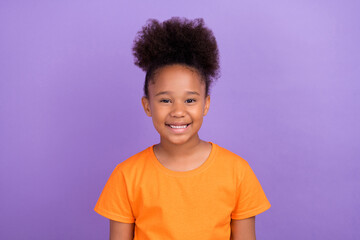 Photo of young cheerful little afro girl happy positive toothy smile isolated over violet color...