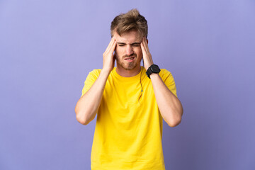 Young handsome blonde man isolated on purple background with headache