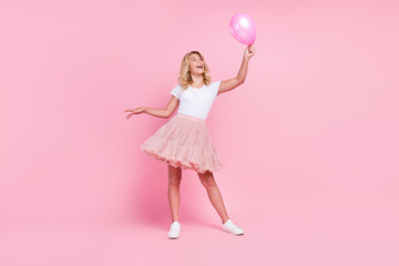 Full length photo of young cheerful girl happy positive smile look air balloon decoration isolated...