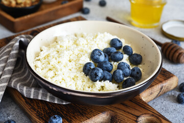Cottage cheese with honey and berries for breakfast. Granola with cottage cheese and nuts.