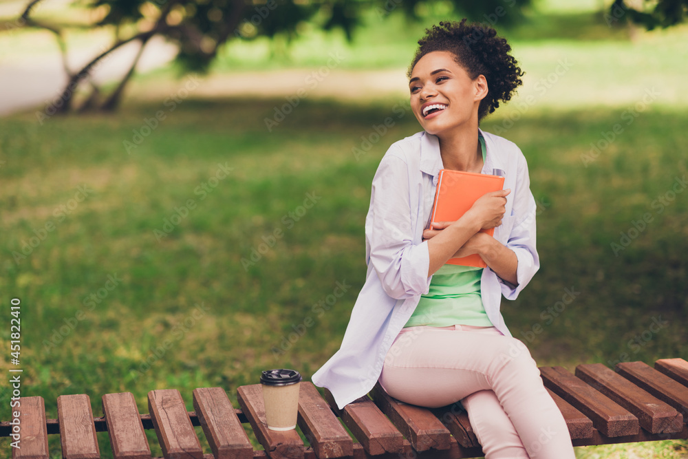 Sticker Photo of happy dream positive dark skin woman look hold hug book smile outdoors outside college park