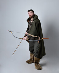 Full length  portrait of  young handsome man  wearing  medieval Celtic adventurer costume with...