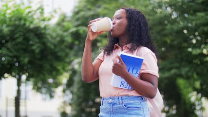 education, school and people concept - happy smiling african american student girl with takeaway coffee cup and math textbook in city - Powered by Adobe