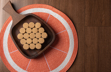 Peanut candy (paçoca or pacoca) Traditional Brazilian candy based on peanuts, placed on a wooden bowl. top view.