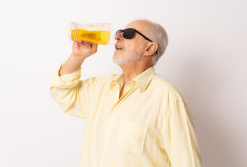 Old man with sunglasses drinking beer isolated over white background.