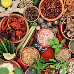Spice and herb collection forming a colorful abstract background. Healthy vegan food high in antioxidants, vitamins, anthocyanins, lycopenes. Flat lay, top view.