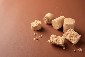 Peanut candy (paçoca or pacoca) Traditional Brazilian peanut-based candy on a leather surface. Selective Focus.