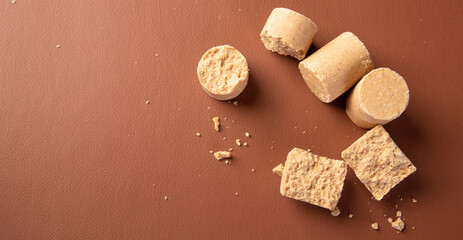 Peanut candy (paçoca or pacoca) Traditional Brazilian peanut-based candy on a leather surface. Selective Focus.