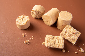Peanut candy (paçoca or pacoca) Traditional Brazilian peanut-based candy on a leather surface. Selective Focus.