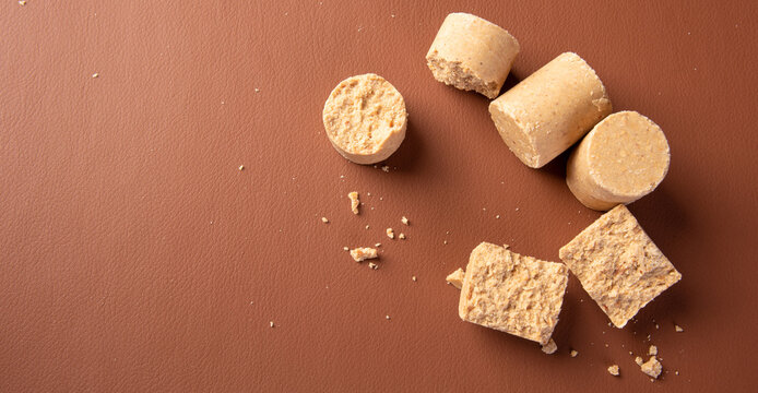 Peanut candy (pa&ccedil;oca or pacoca) Traditional Brazilian peanut-based candy on a leather surface. Selective Focus.